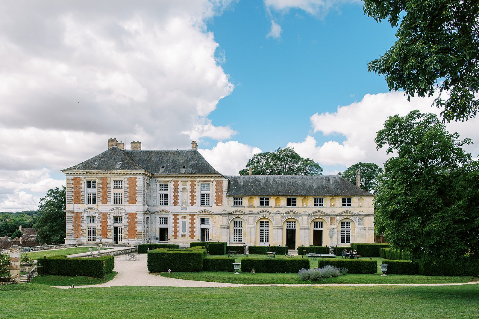 French chateau wedding venue with manicured gardens at golden hour